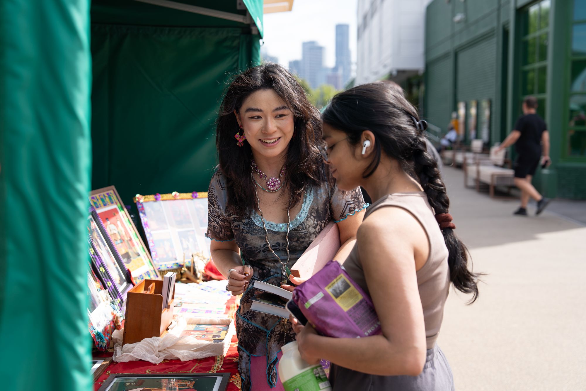 Friends browsing a Craft & Flea stall on the Canada Water dockside.