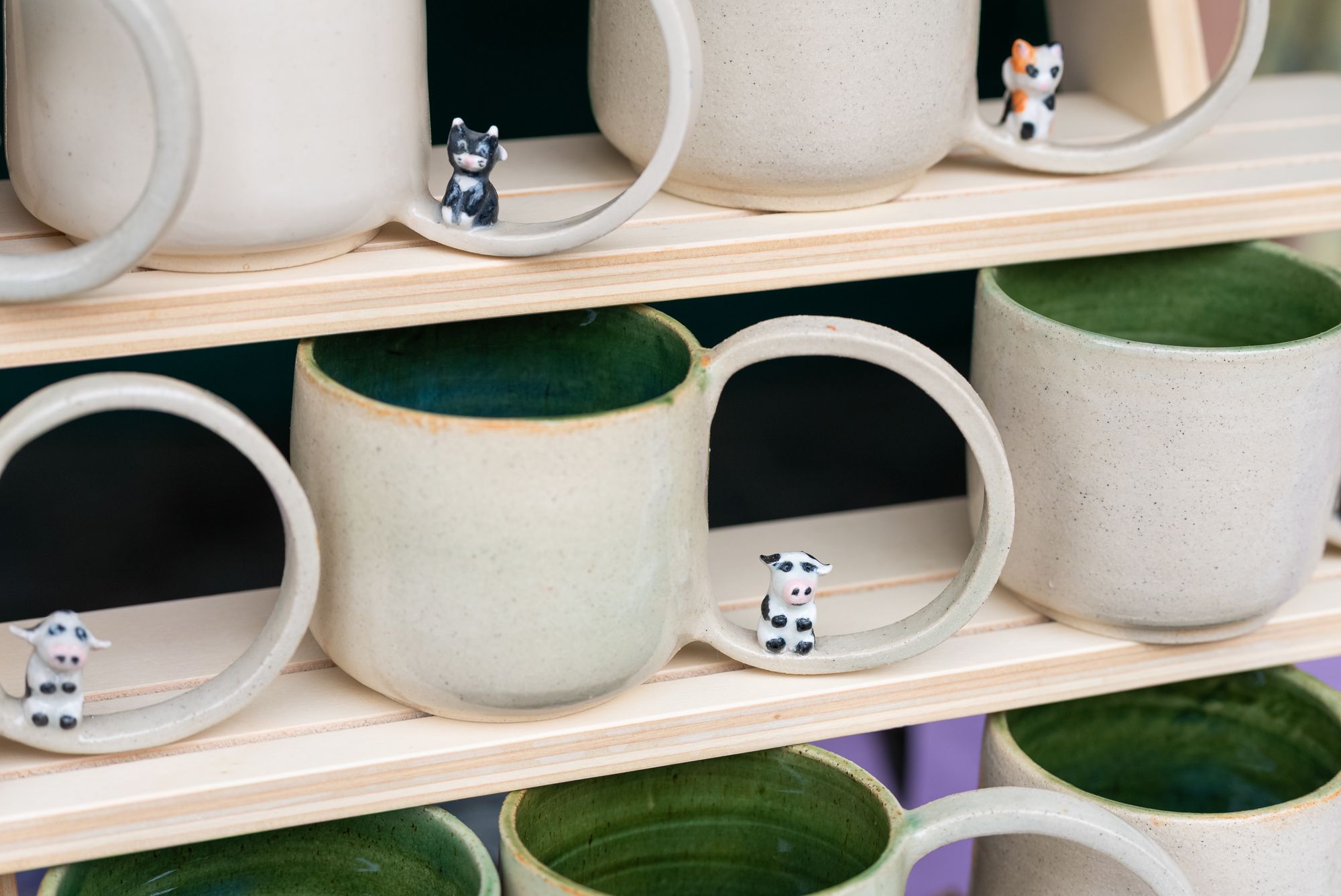 Handmade mugs on a trader's shelves at the Craft & Flea market, Canada Water, London.