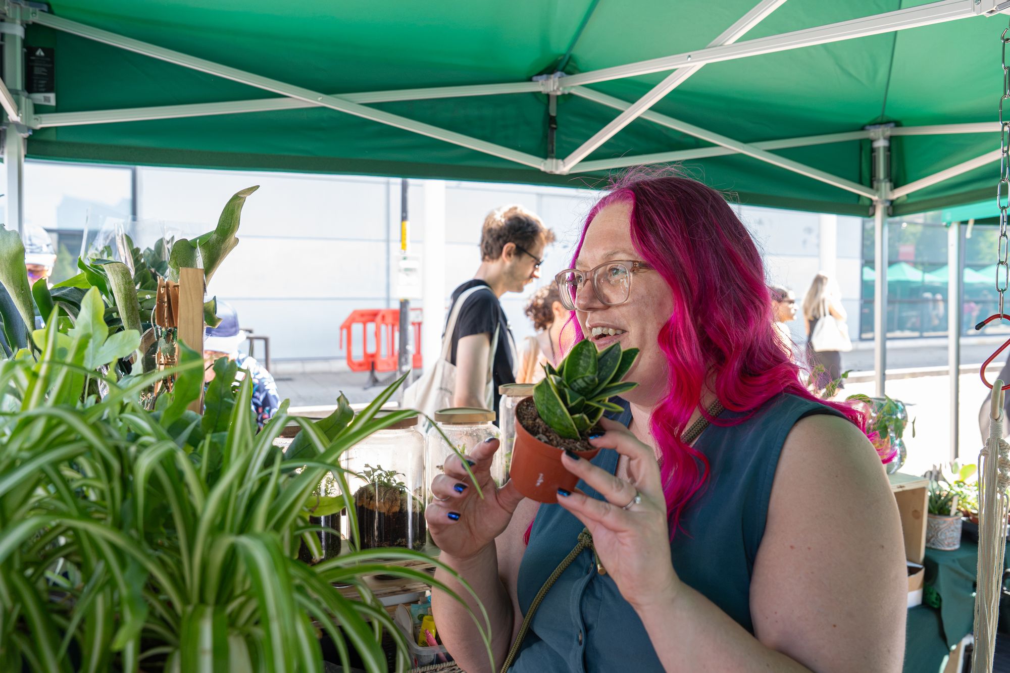 A plant trader with a succulent at her Craft & Flea stall, Canada Water, London SE16.