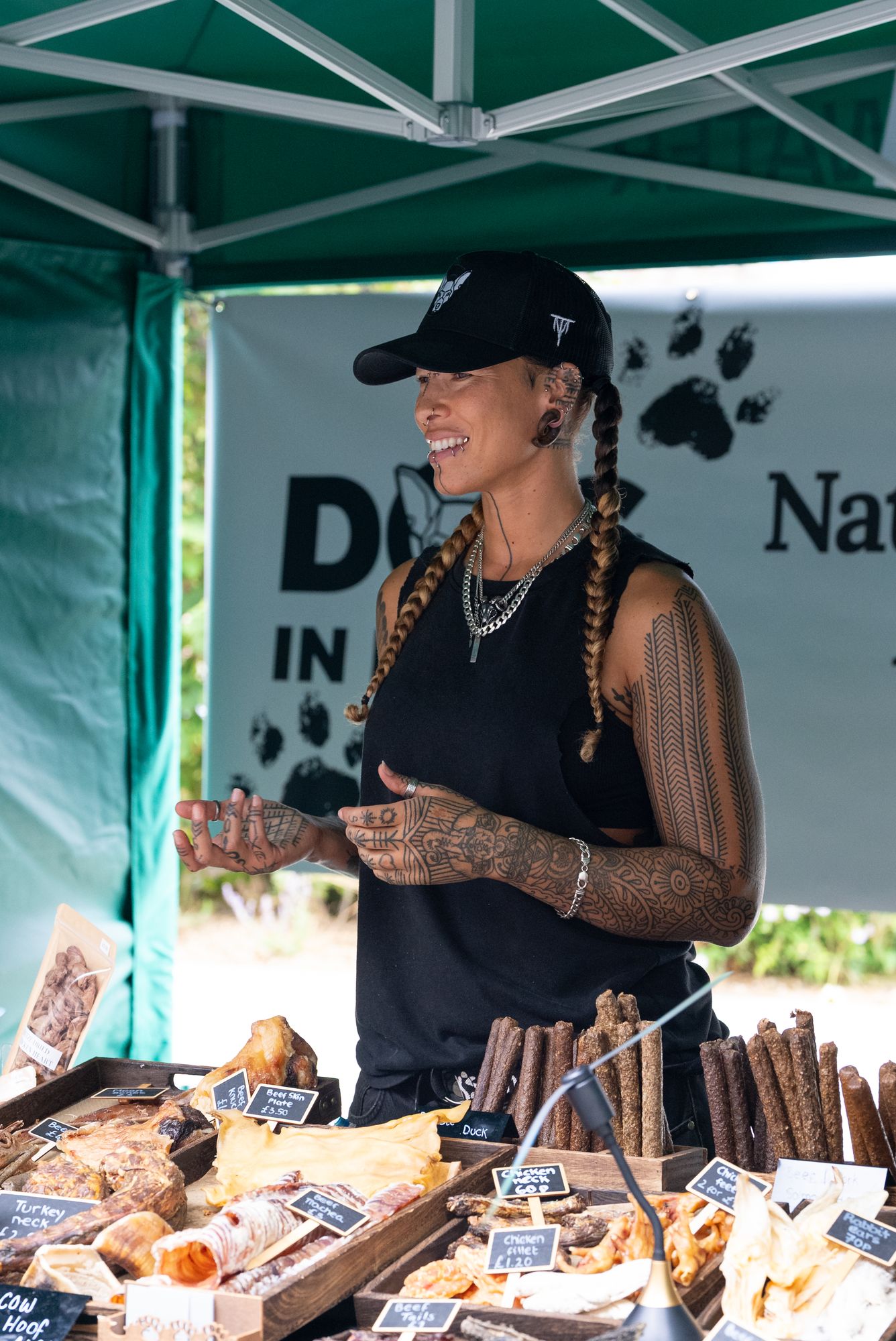 A trader serving at a natural pet treats stall at the Craft & Flea market, Canada Water.