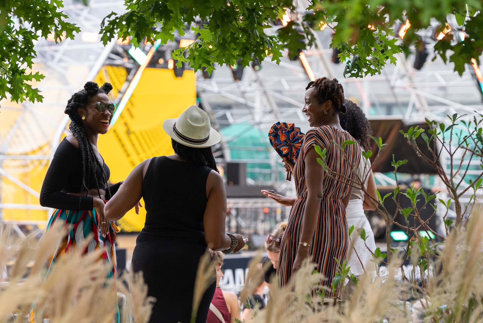 Festival-goers dancing among the planting around Canada Dock during Round the Dock.