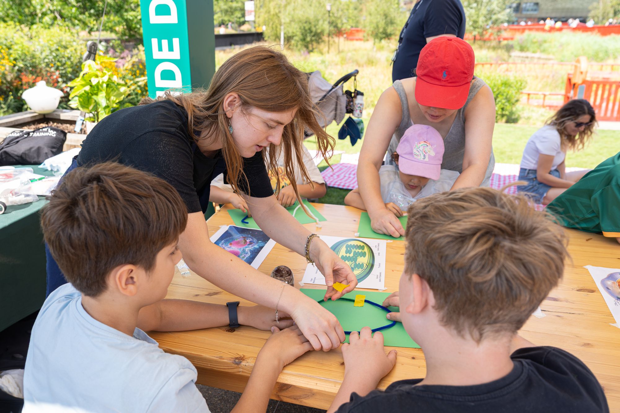 Children making crafts at a table in the Dockside Den family zone, Round the Dock, Canada Water.