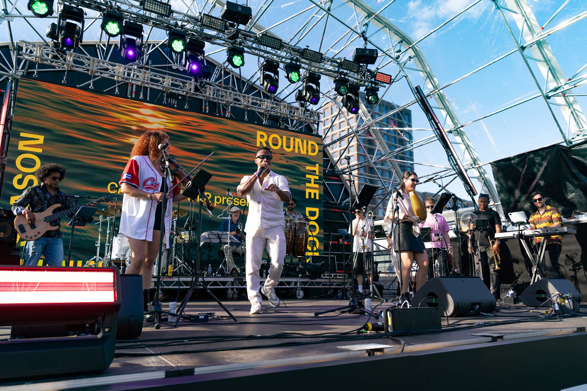 Singers fronting the live salsa band on the Round the Dock floating stage, Canada Water.