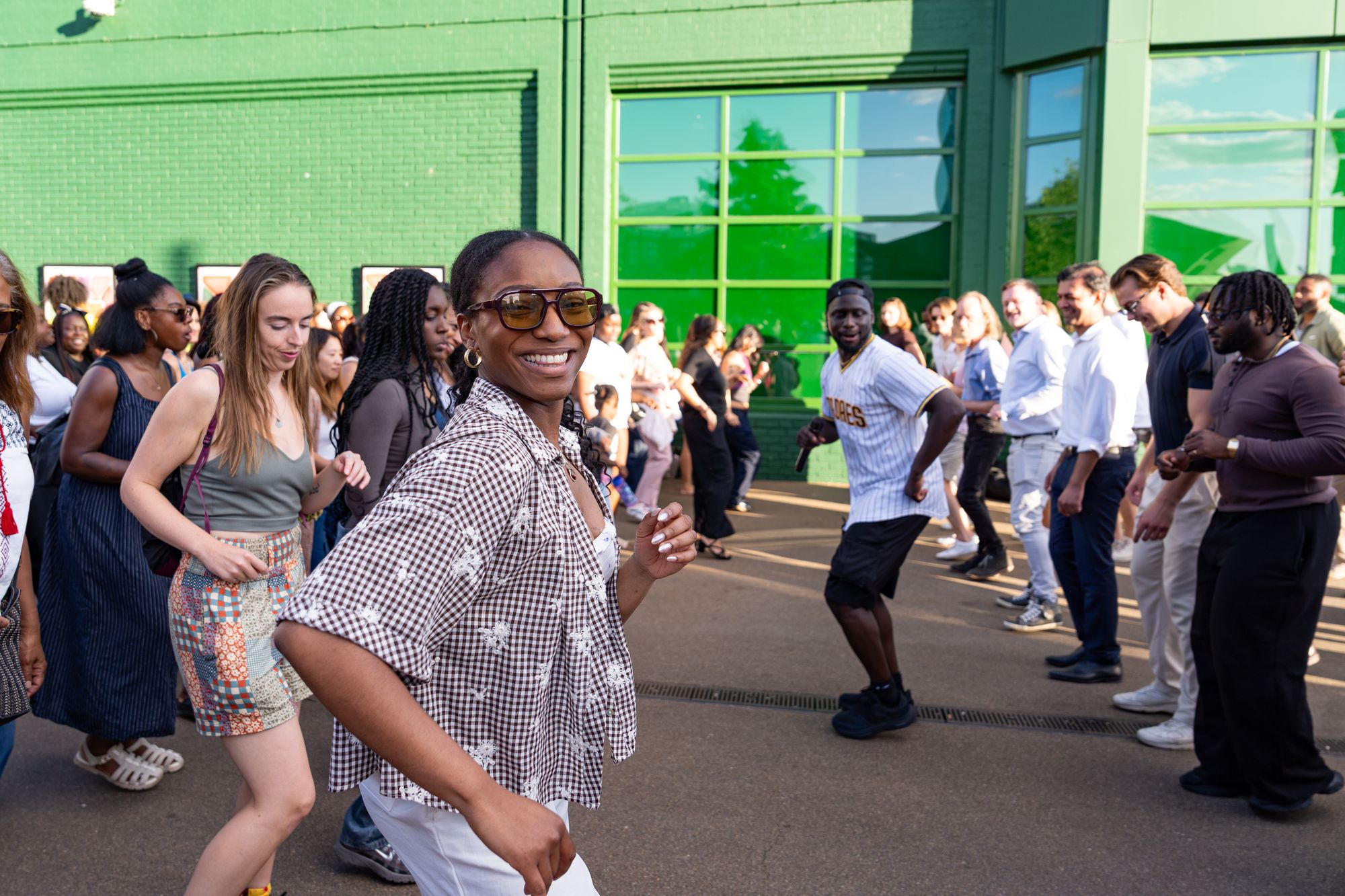 A dancer smiling mid-step in the Round the Dock salsa class at Canada Water.