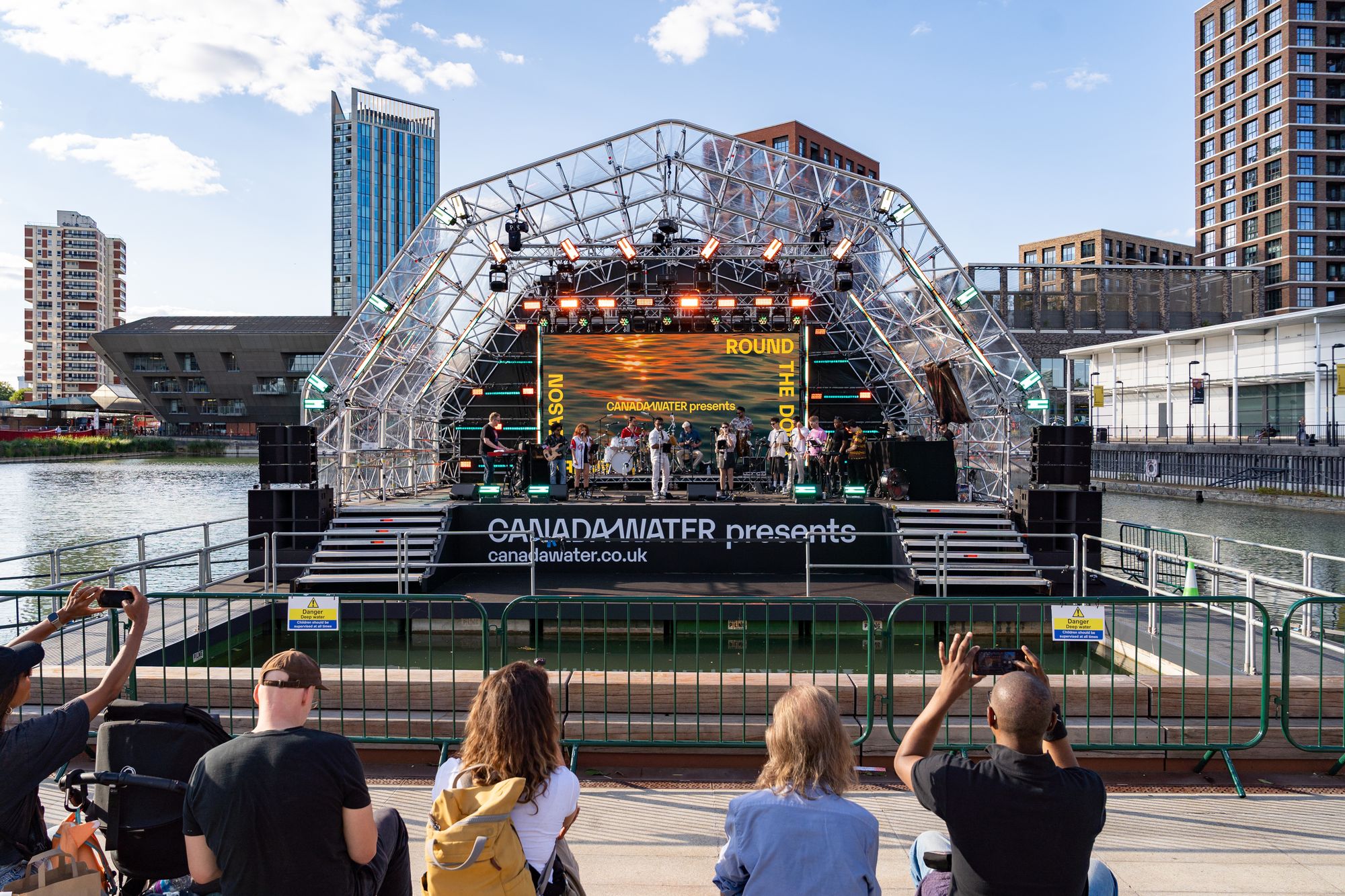 The crowd watching the salsa band on the floating stage across Canada Dock.