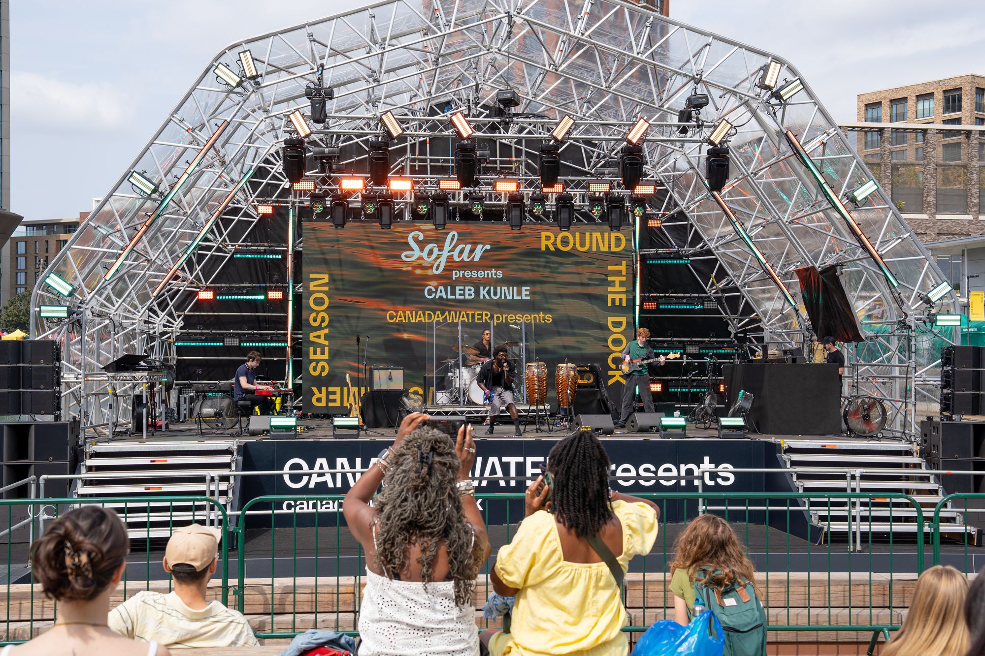 Children watching the Sofar Sounds set at the floating stage on Canada Dock.