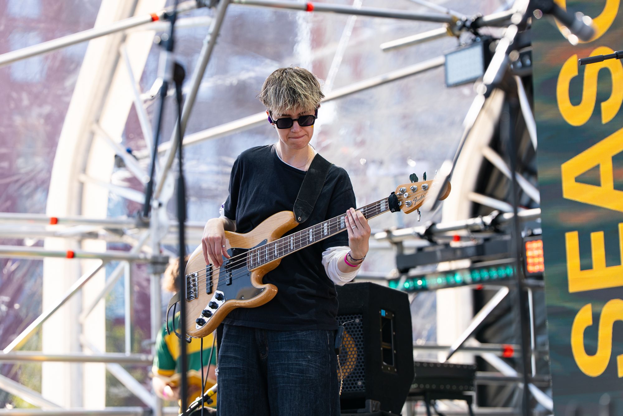 The bassist in the Spit Night band on the floating stage at Canada Water, London.