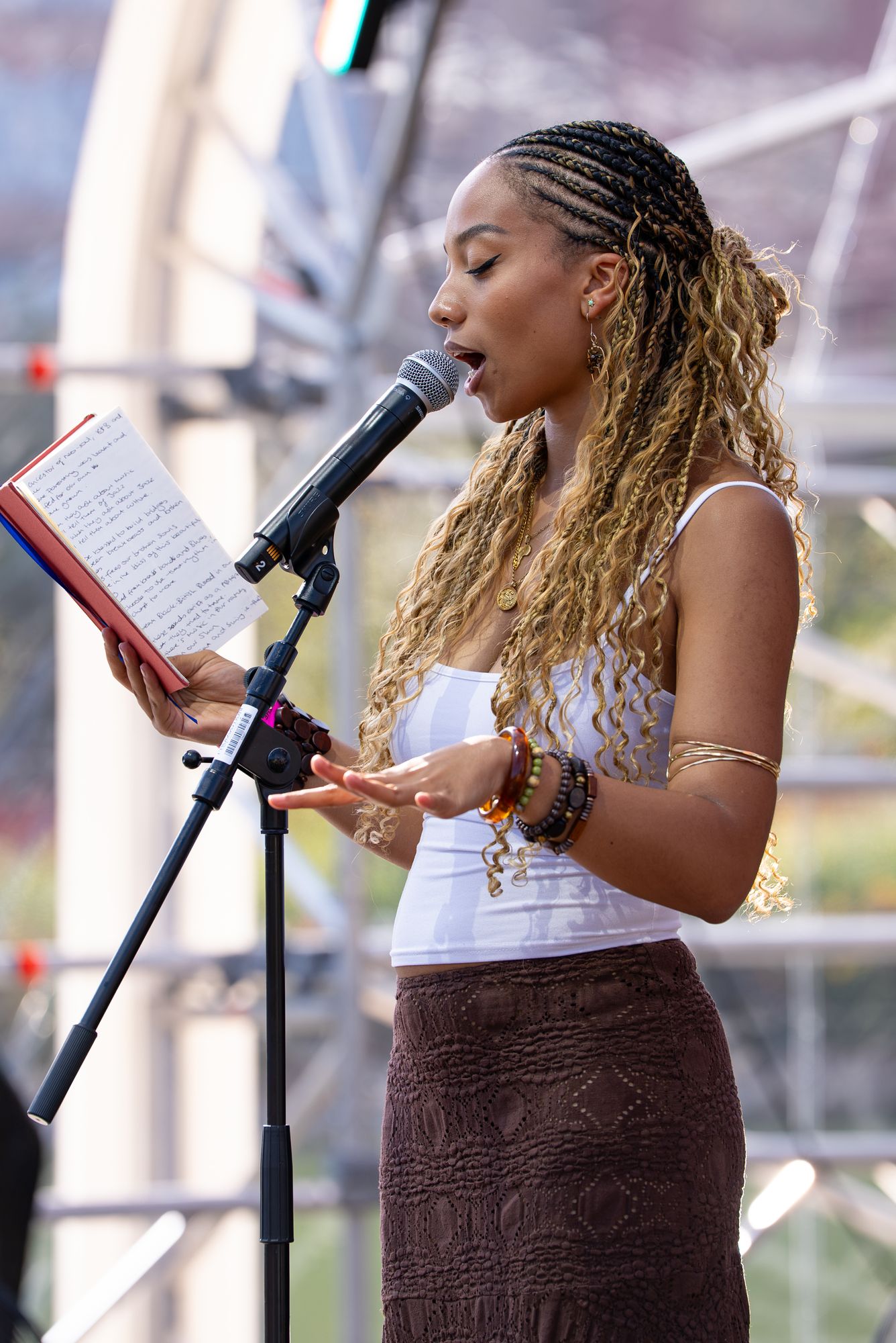 A spoken-word poet reading on the floating stage at Spit Night, Round the Dock, Canada Water.