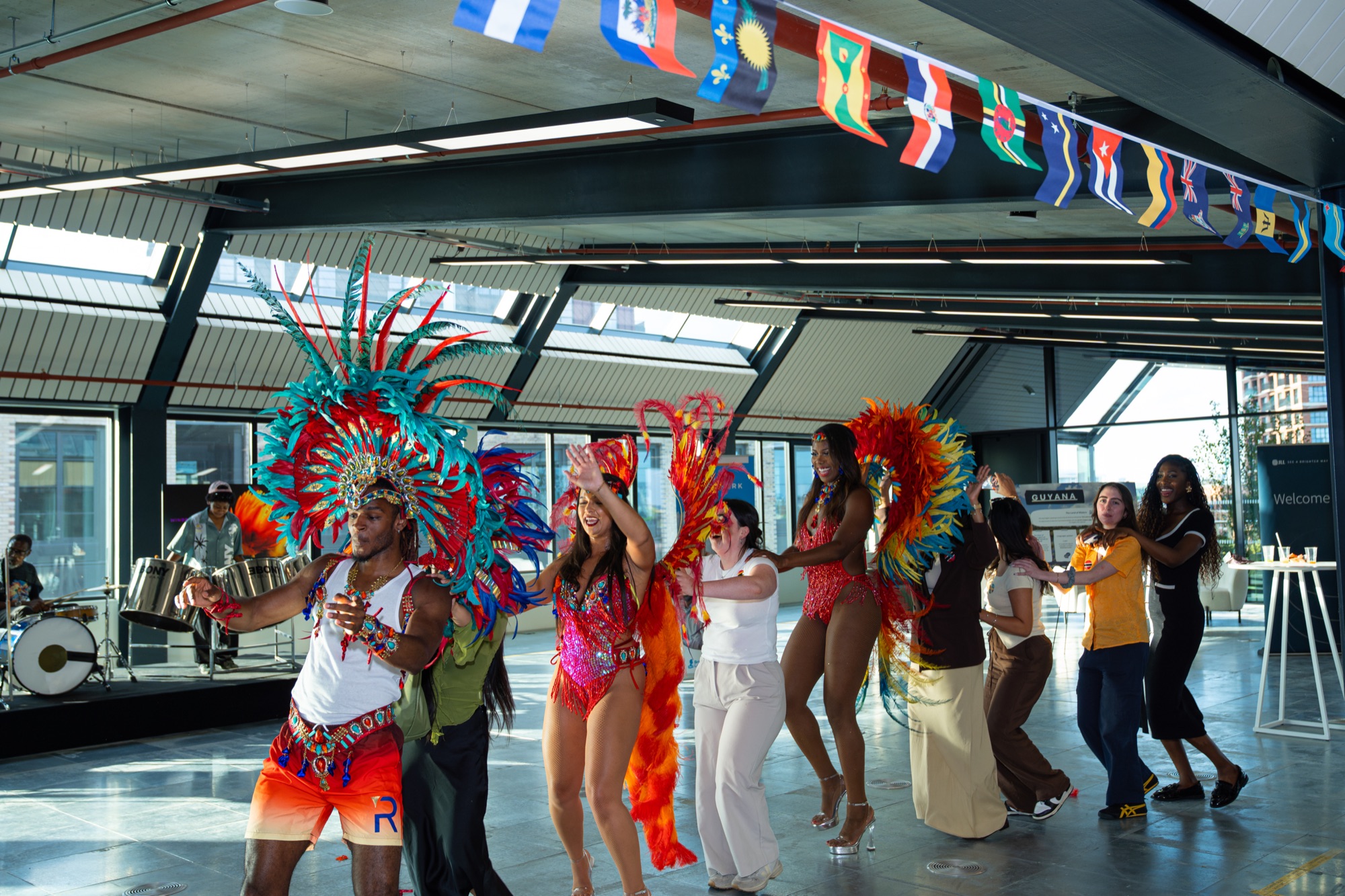 Carnival dancers lead guests onto the floor at the Windrush celebration hosted by REACH with CBRE and JLL.