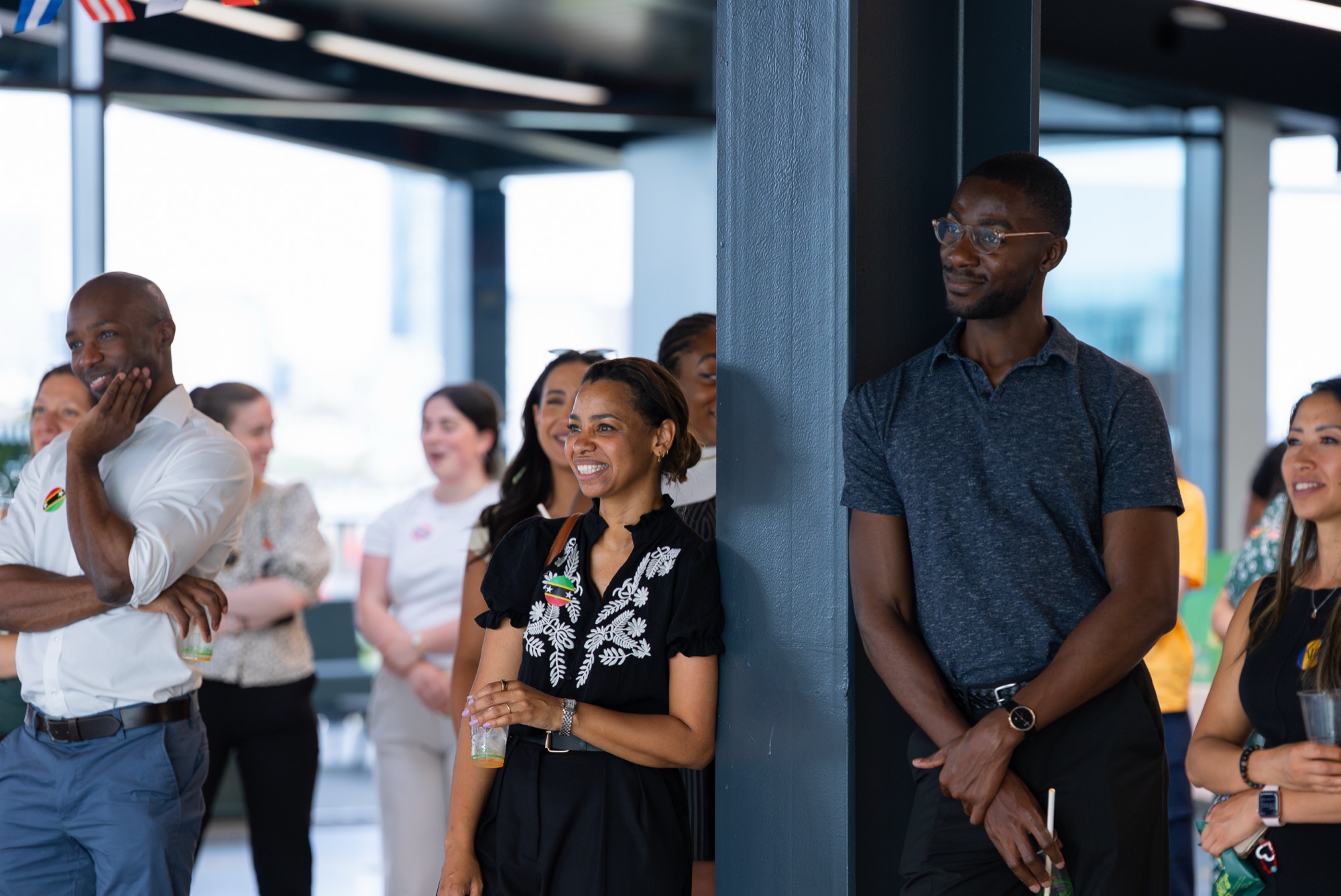 Guests smile during the speeches at the Windrush celebration — event photography for a corporate heritage event in London.