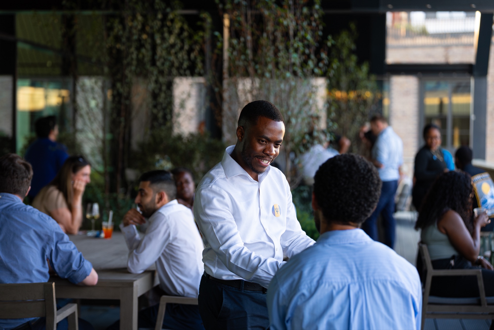 Guests catching up over drinks at the Windrush celebration, Canada Water, London.
