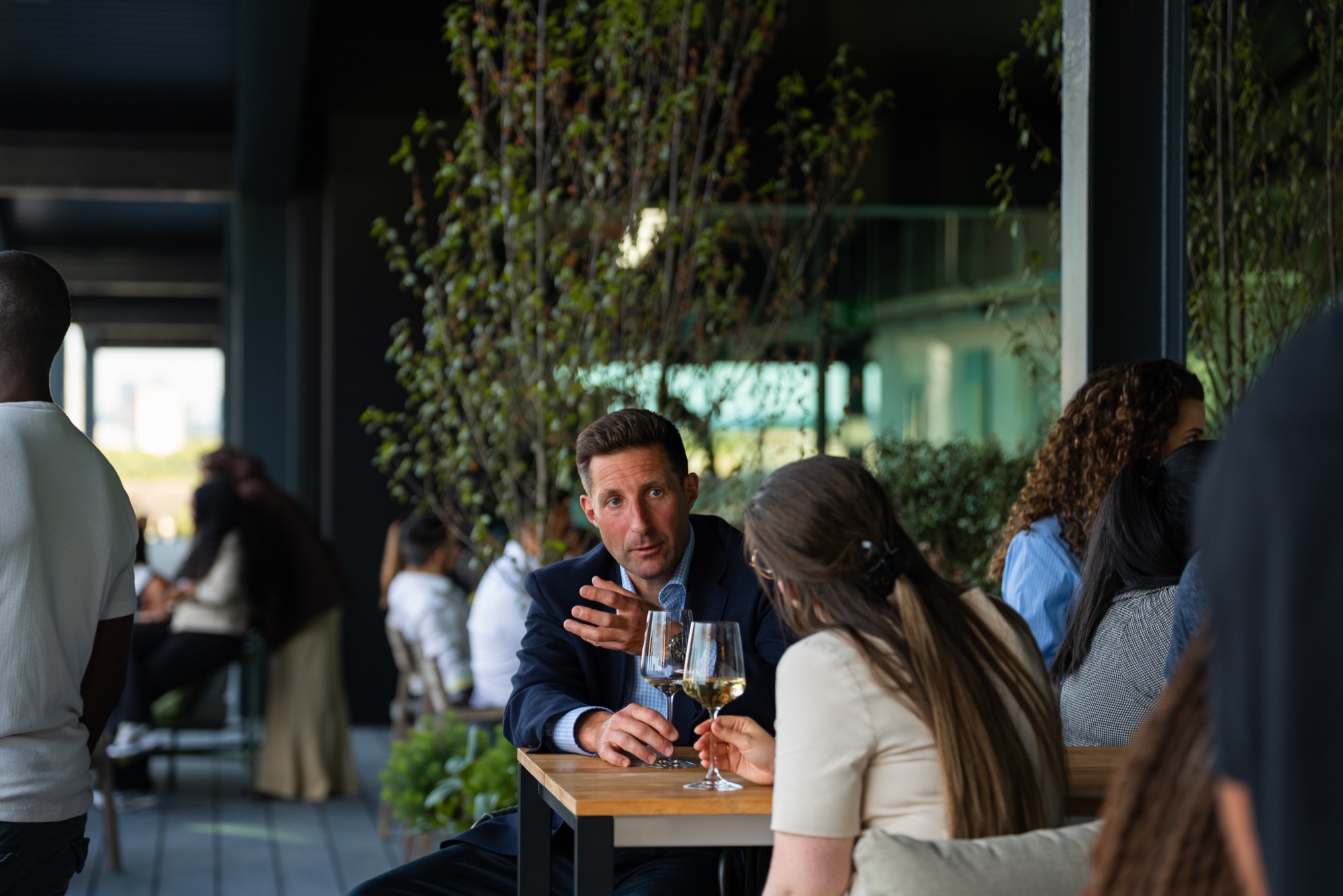 Guests talking over drinks at the tables during the Windrush celebration at Canada Water, London.