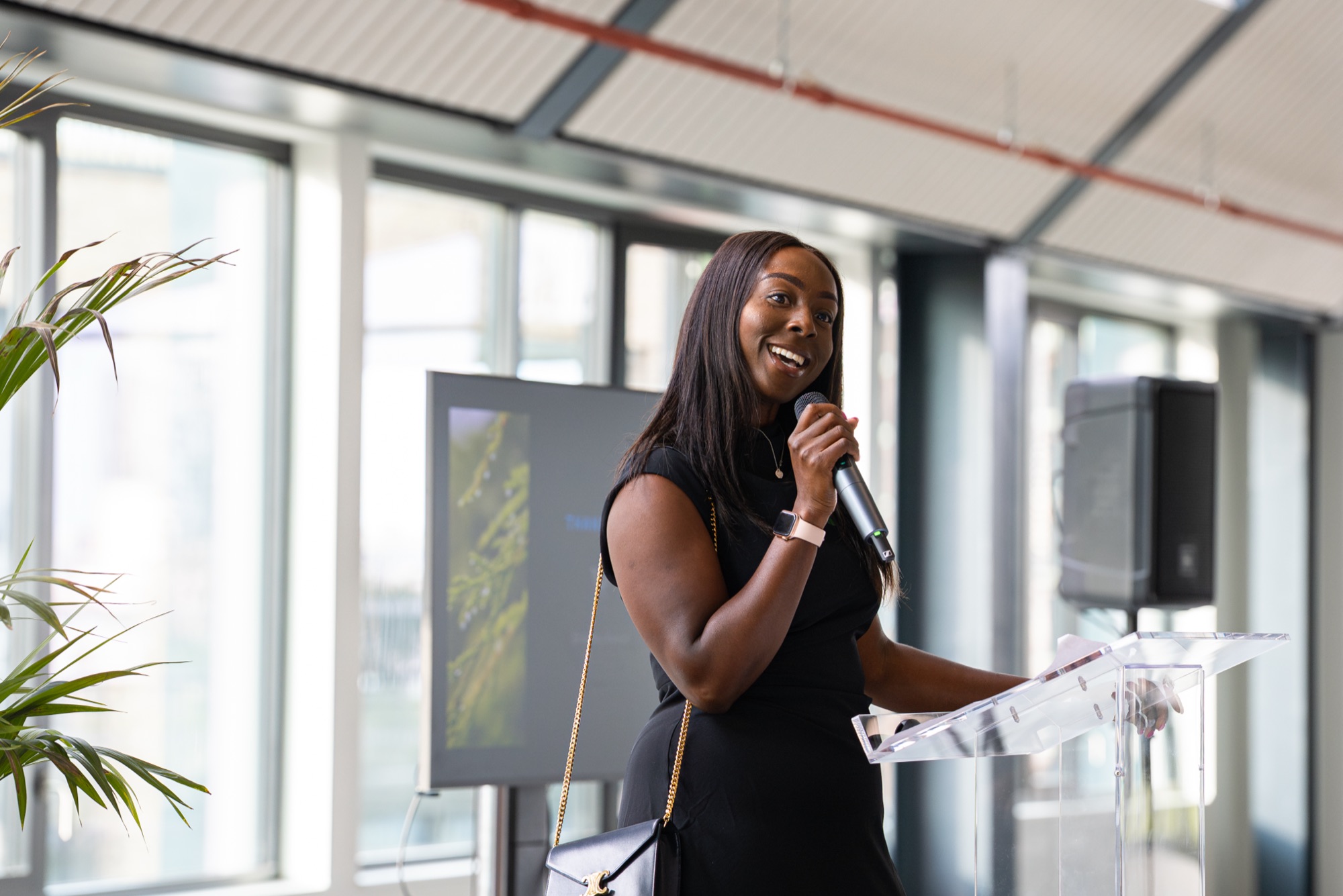 A speaker addresses guests at the Windrush celebration in the Dock Shed, Canada Water, London SE16.