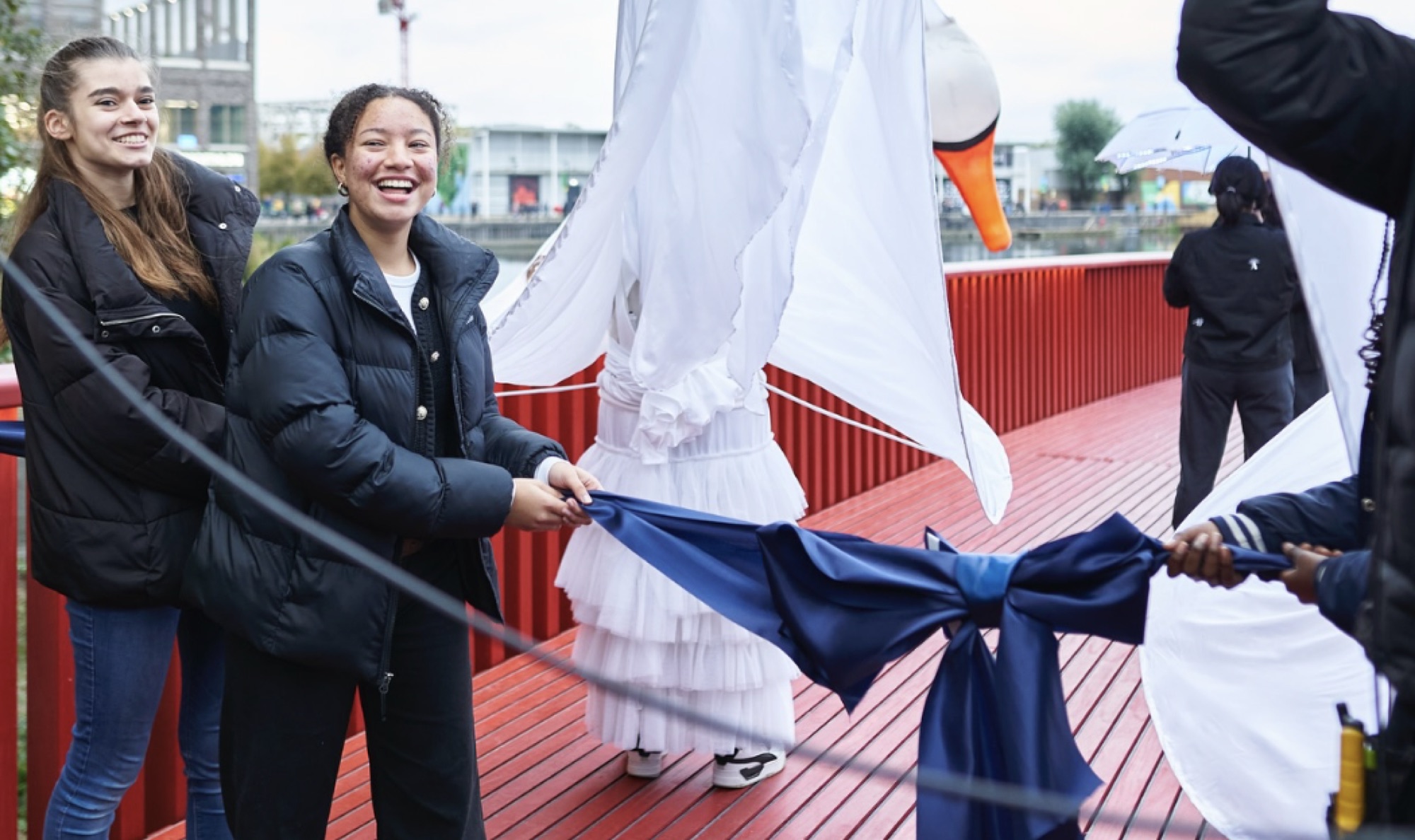 Two guests pull the ribbon at the official opening moment — one of the most important frames from the launch day