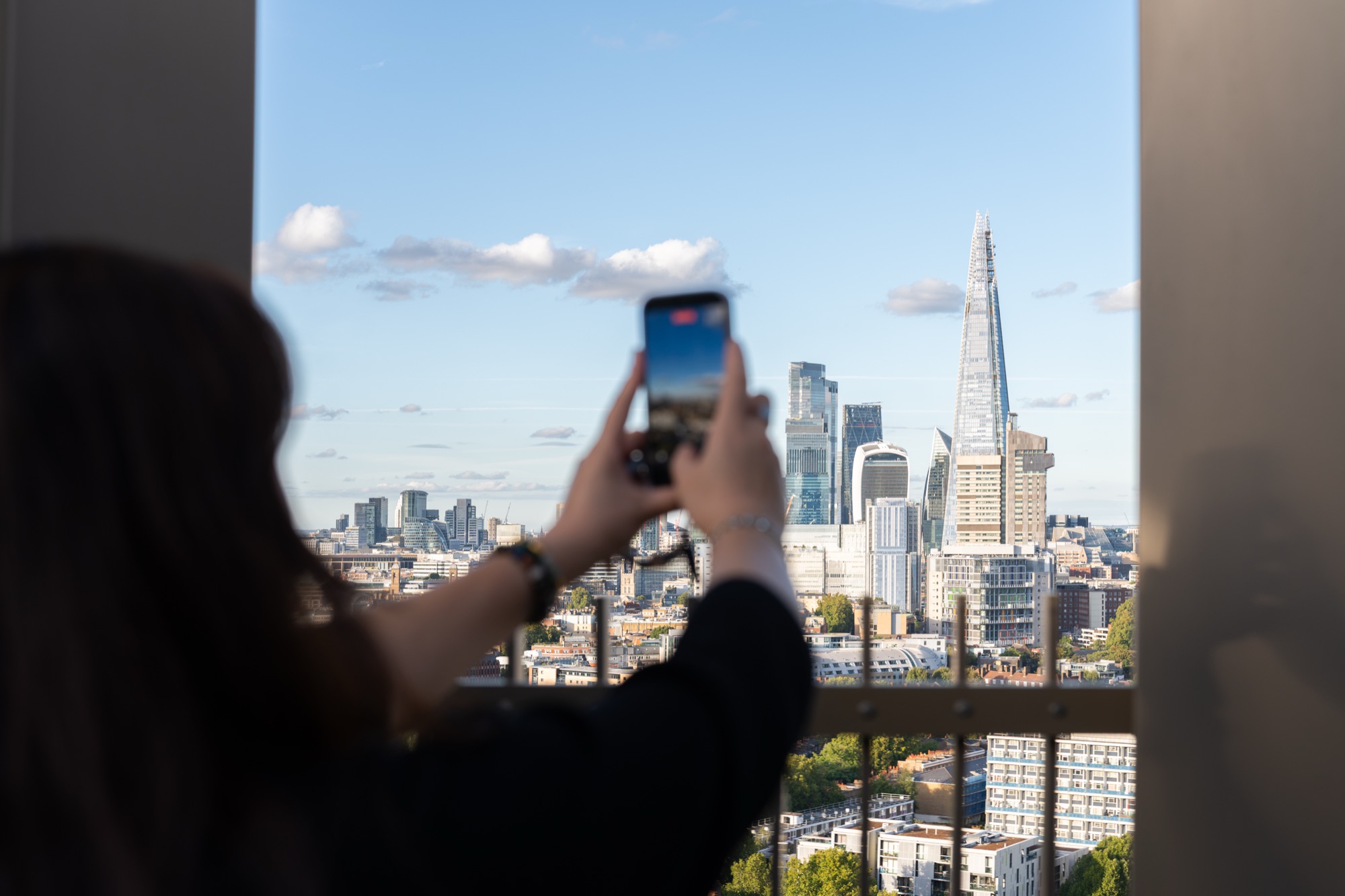 A guest photographs the Shard from the Arbour Heights terrace — the view that sells the building.
