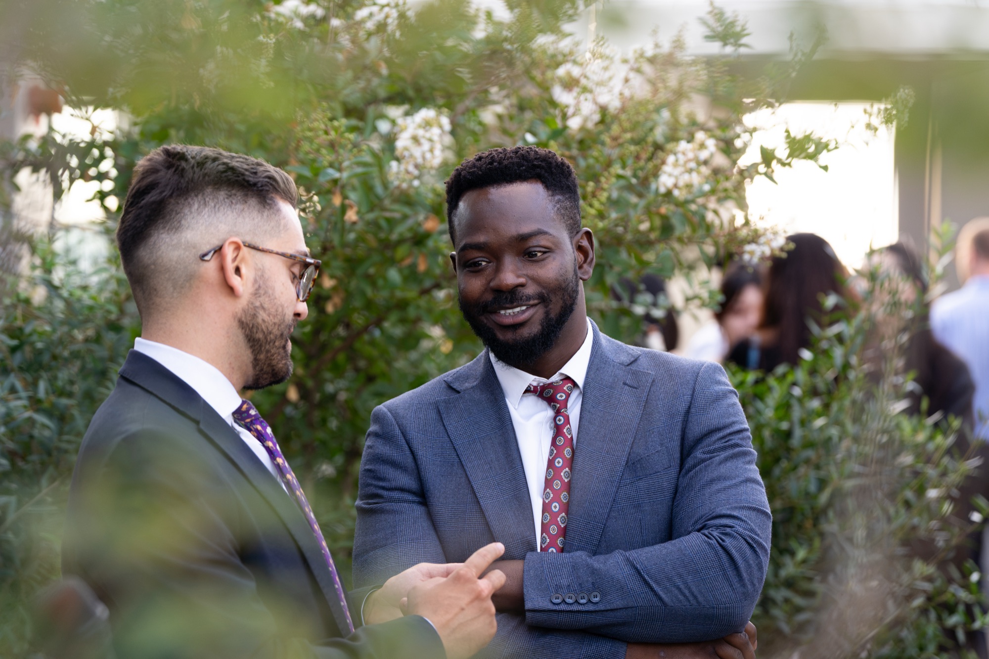 Two guests in conversation among the terrace planting at the Arbour Heights residential launch.