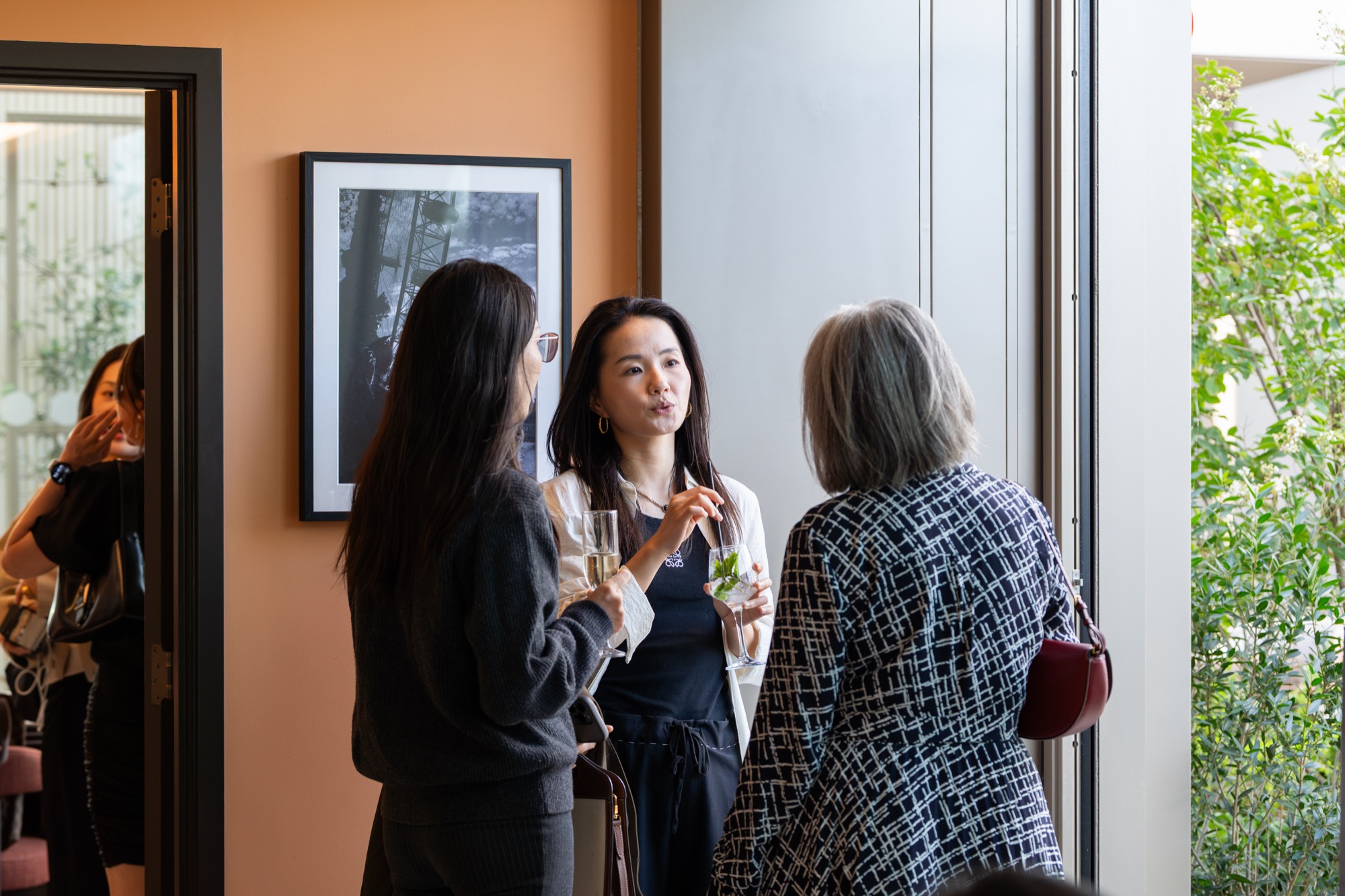 Guests with drinks in the interior reception space at the Arbour Heights launch, Elephant Park, London.