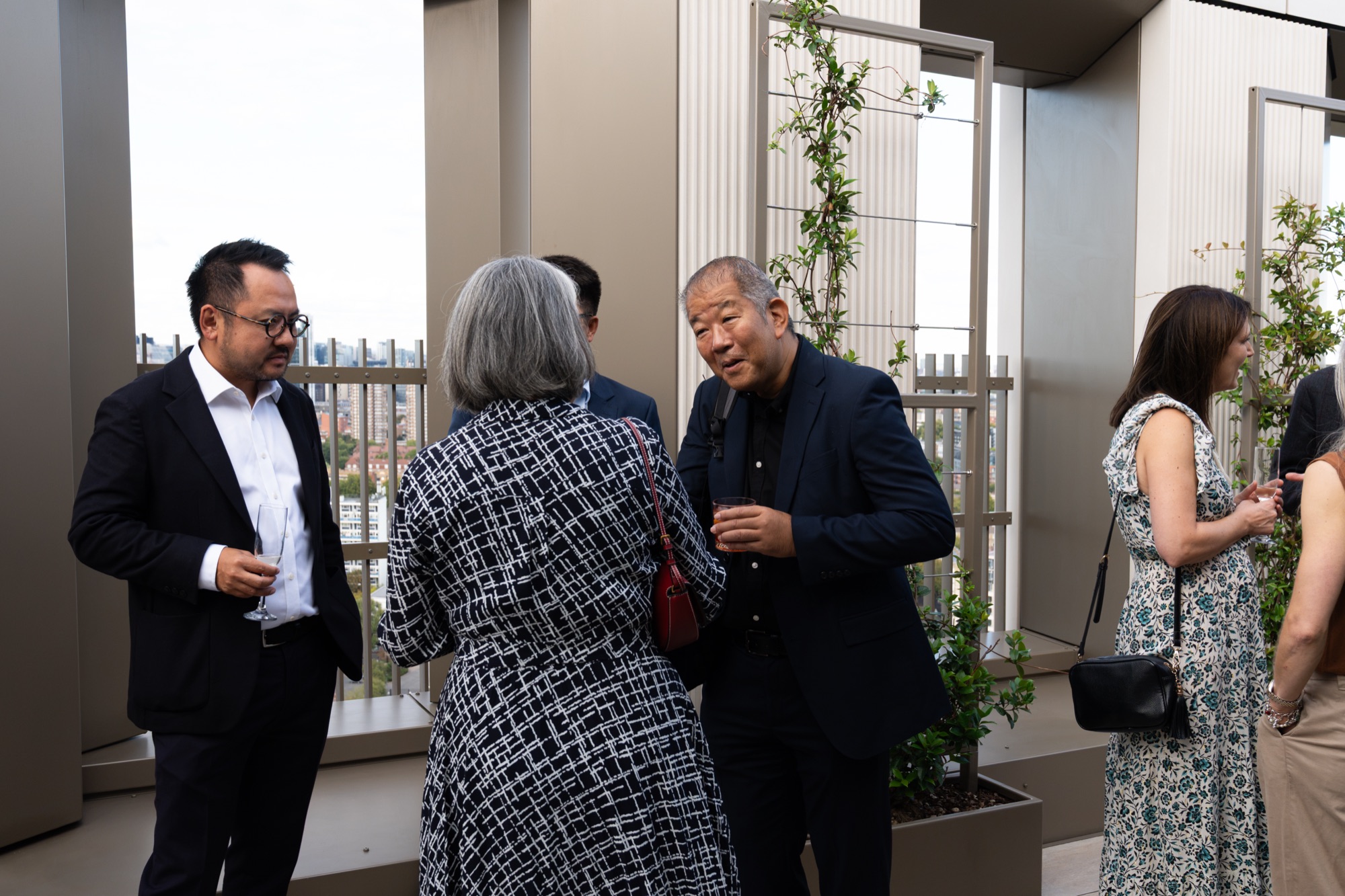 Guests mingling on the terrace at the Arbour Heights launch at The Wilderly, London.