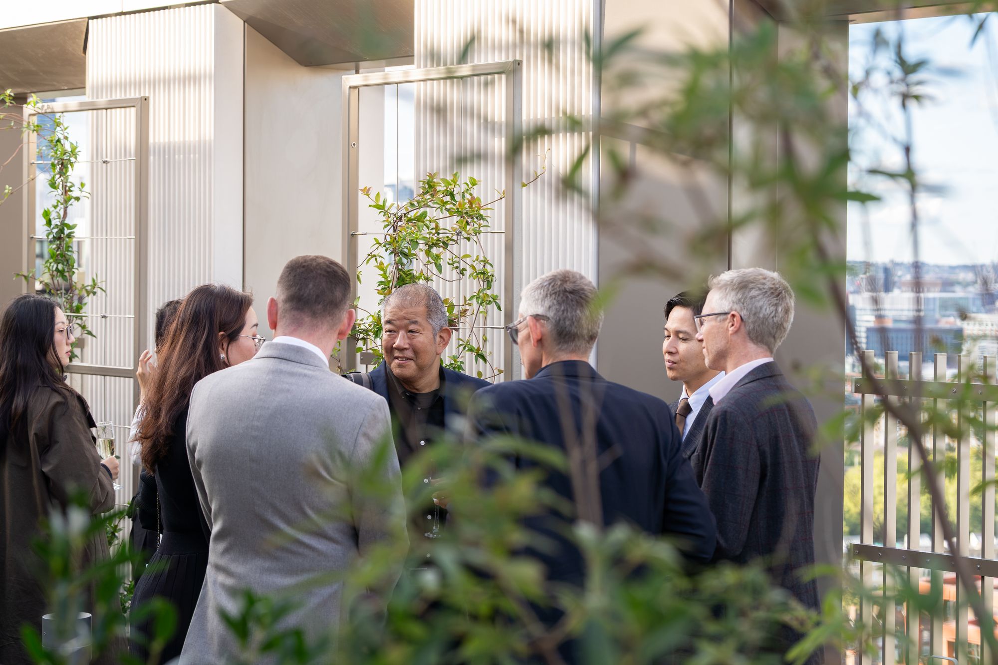 Guests networking among the planting of the roof garden at the Arbour Heights launch event, Elephant Park, London.