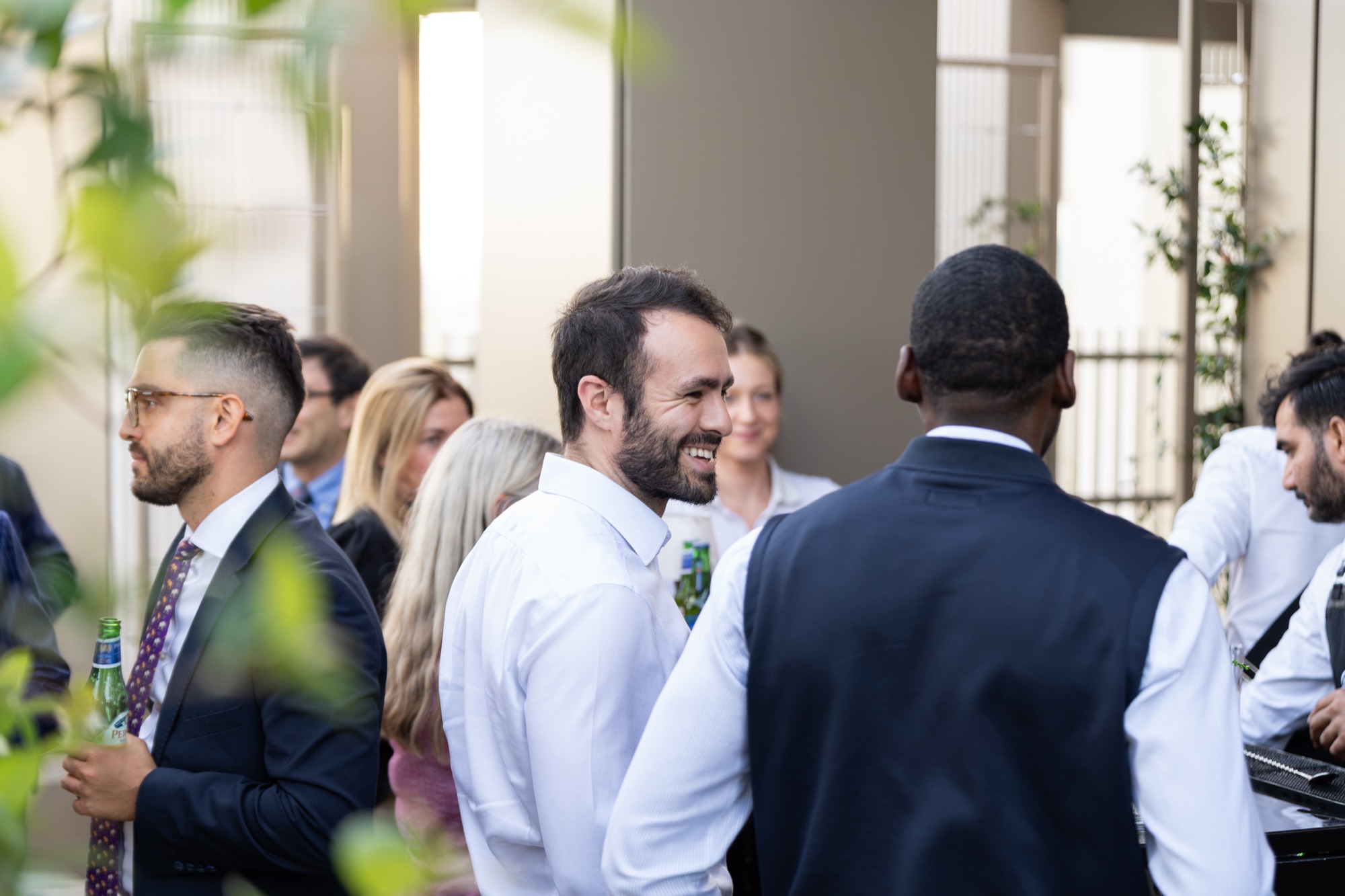 Guests networking in a group on the roof terrace at Lendlease's Arbour Heights launch, Elephant Park.