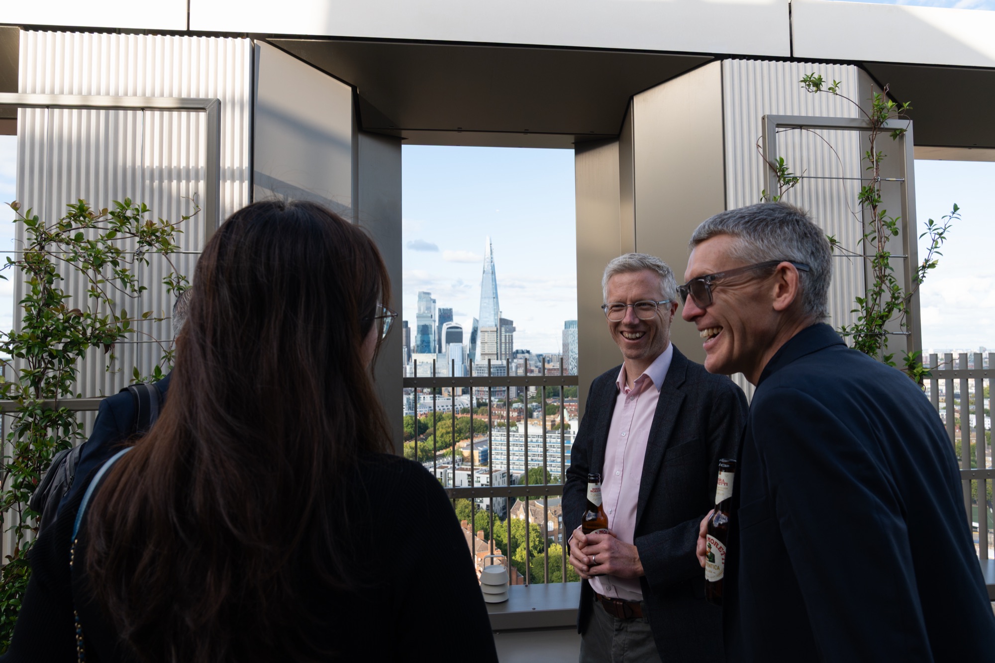 Guests talking on the Arbour Heights terrace with the City skyline beyond — event photography in London SE17.