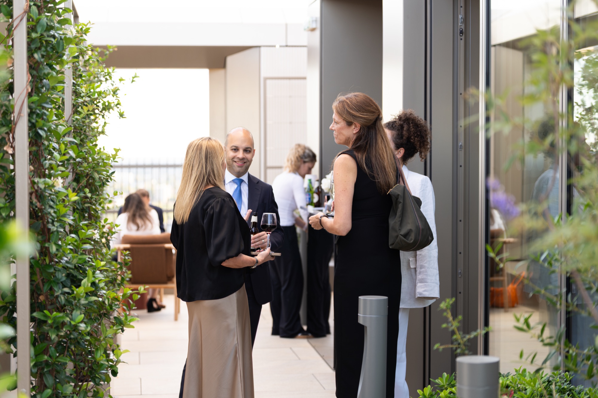 Guests along the terrace walkway at Arbour Heights, The Wilderly — documenting how the building's outdoor spaces are used.