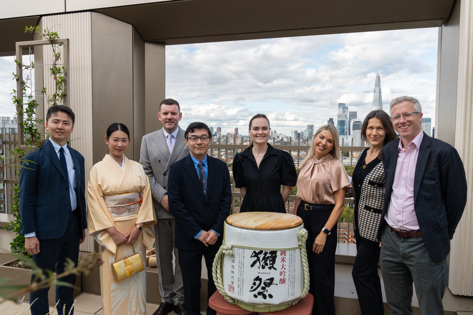 Guests and hosts gathered around the sake barrel before the Kagami Biraki at Lendlease's Arbour Heights launch, with the Shard on the skyline.