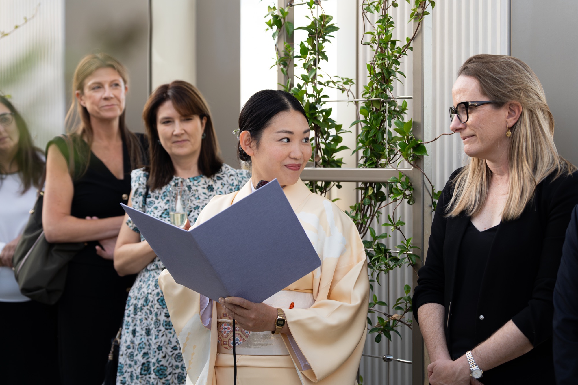 A guest in traditional kimono reads an address to the audience at Lendlease's Arbour Heights launch in London.