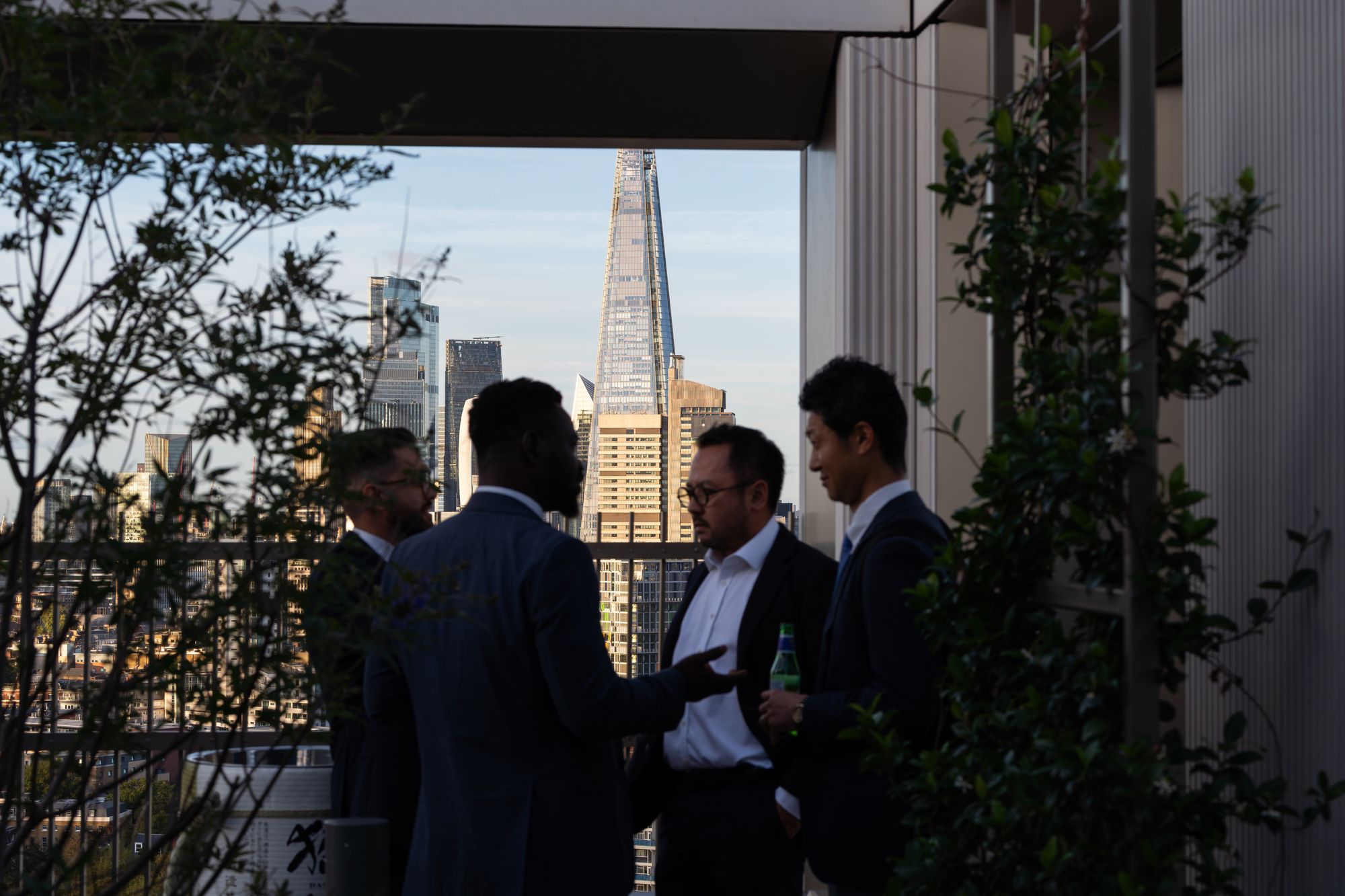 Guests networking on the terrace with the Shard framed behind them at the Arbour Heights launch, Elephant Park.