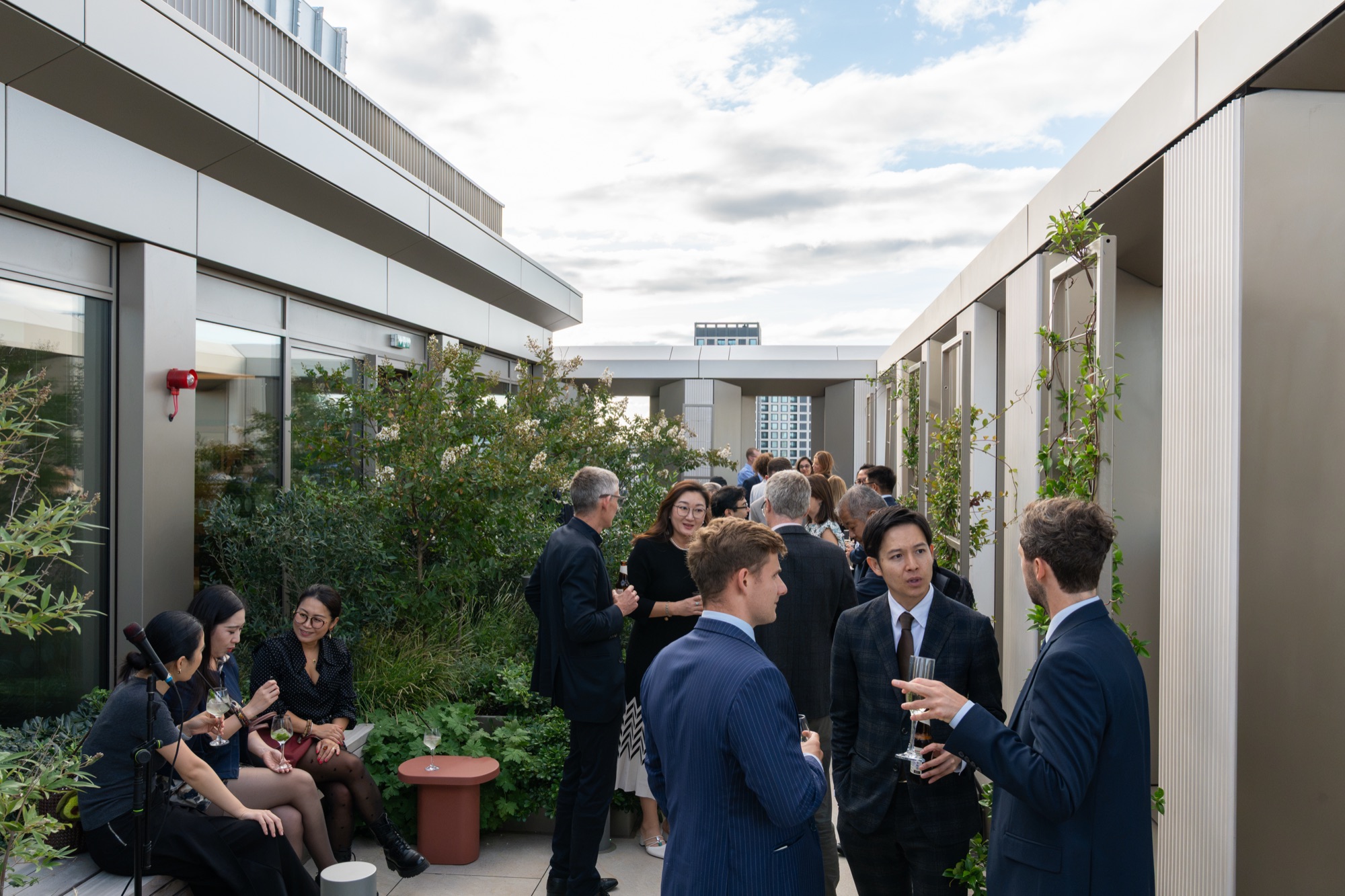 Guests gathered across the planted roof terrace at Arbour Heights — capturing the building's amenity space for Lendlease.