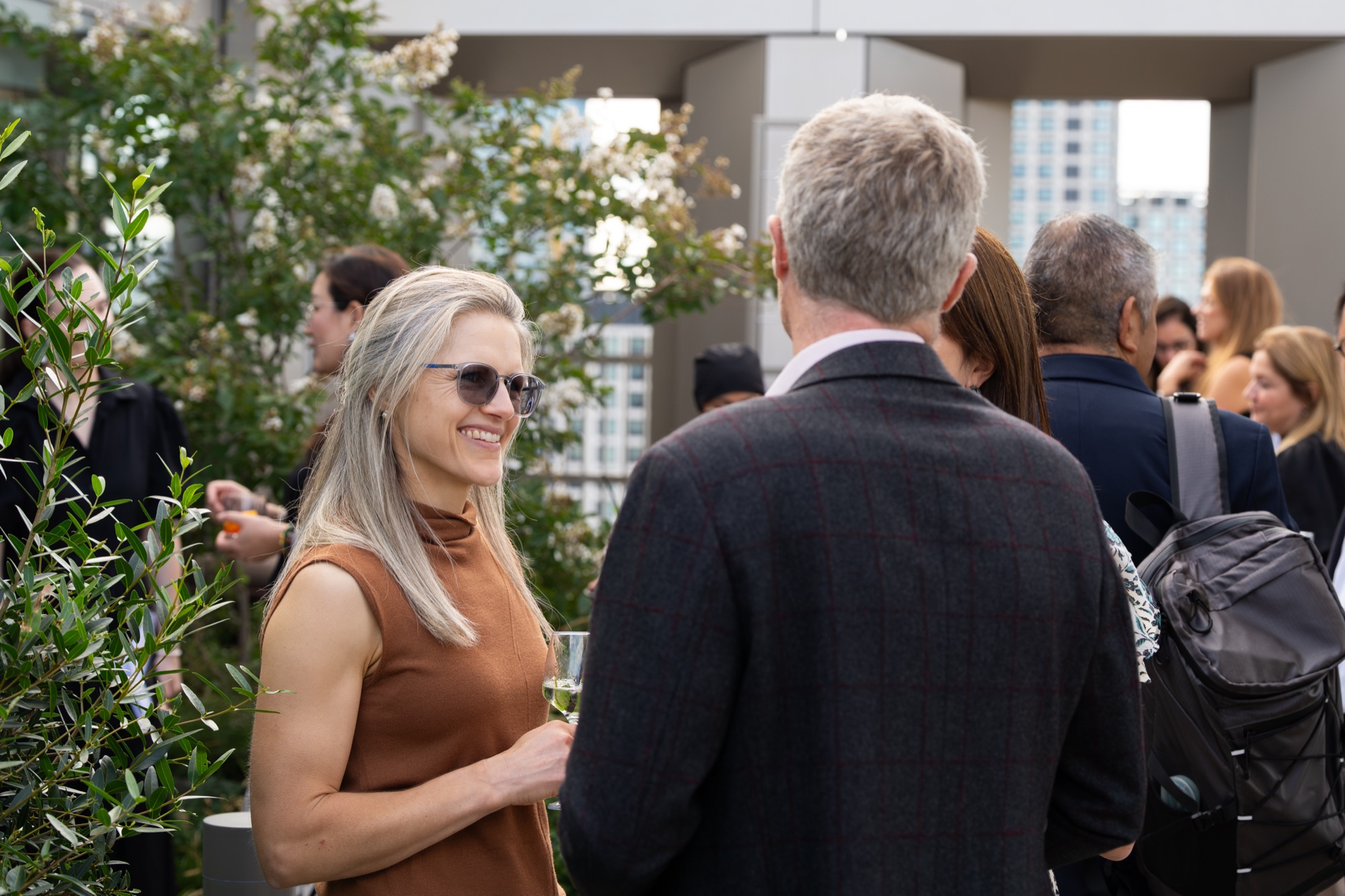 Guests arriving and talking on the rooftop at the Arbour Heights launch event, Elephant Park, London.