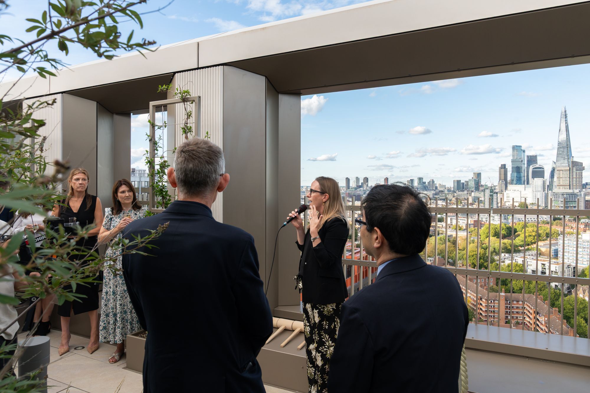 A welcome address to guests on the Arbour Heights roof terrace, with views across Elephant Park towards the City.