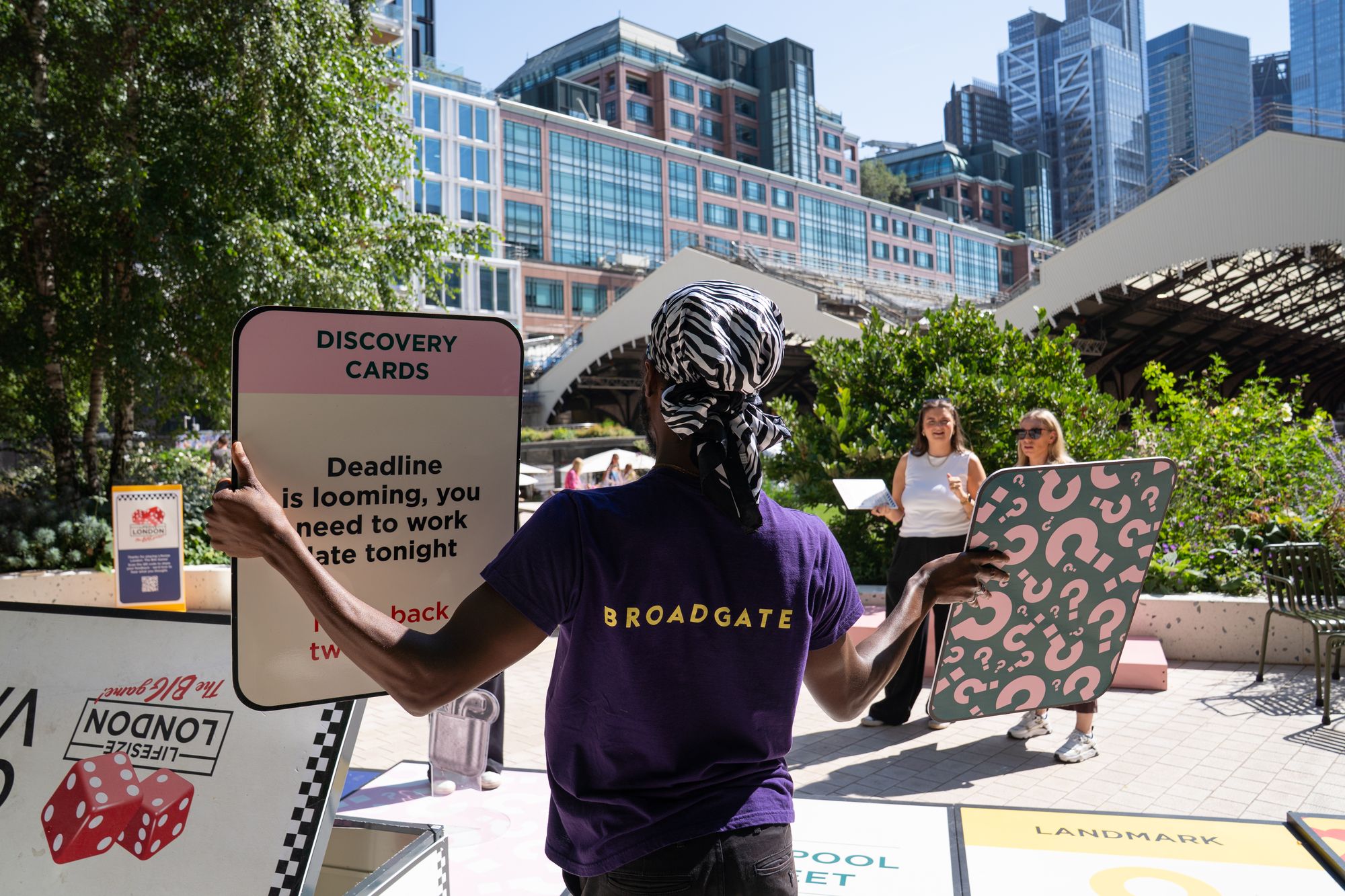 A Broadgate game host holds up a Discovery Card in Exchange Square during the Lifesize London finale.