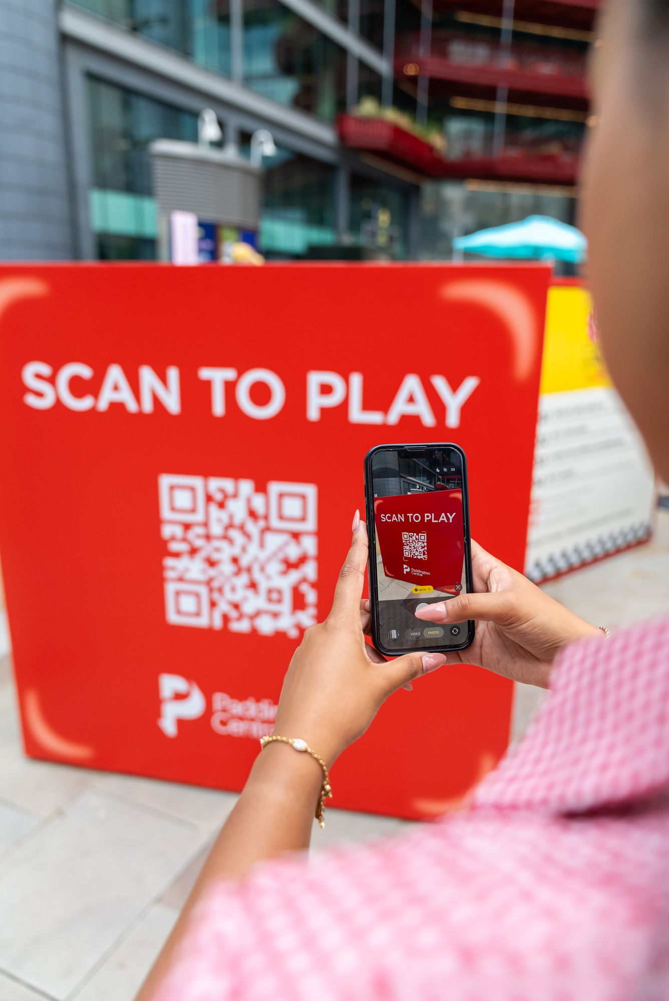 A player scanning the Scan to Play QR code to join Lifesize London through the Paddington Central app.