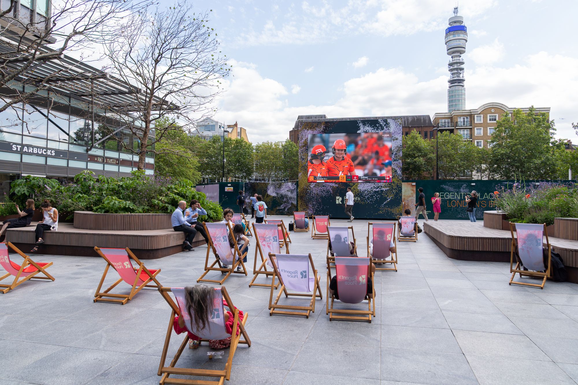 The outdoor big screen and deckchairs at Regent's Place during the Lifesize London summer programme.