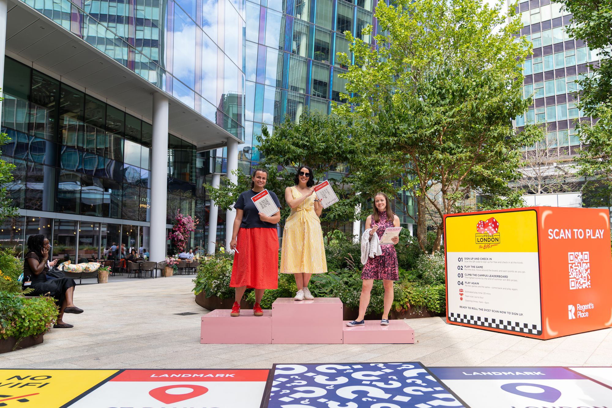 Players celebrating on the winners' podium at the end of a Lifesize London game at Regent's Place.